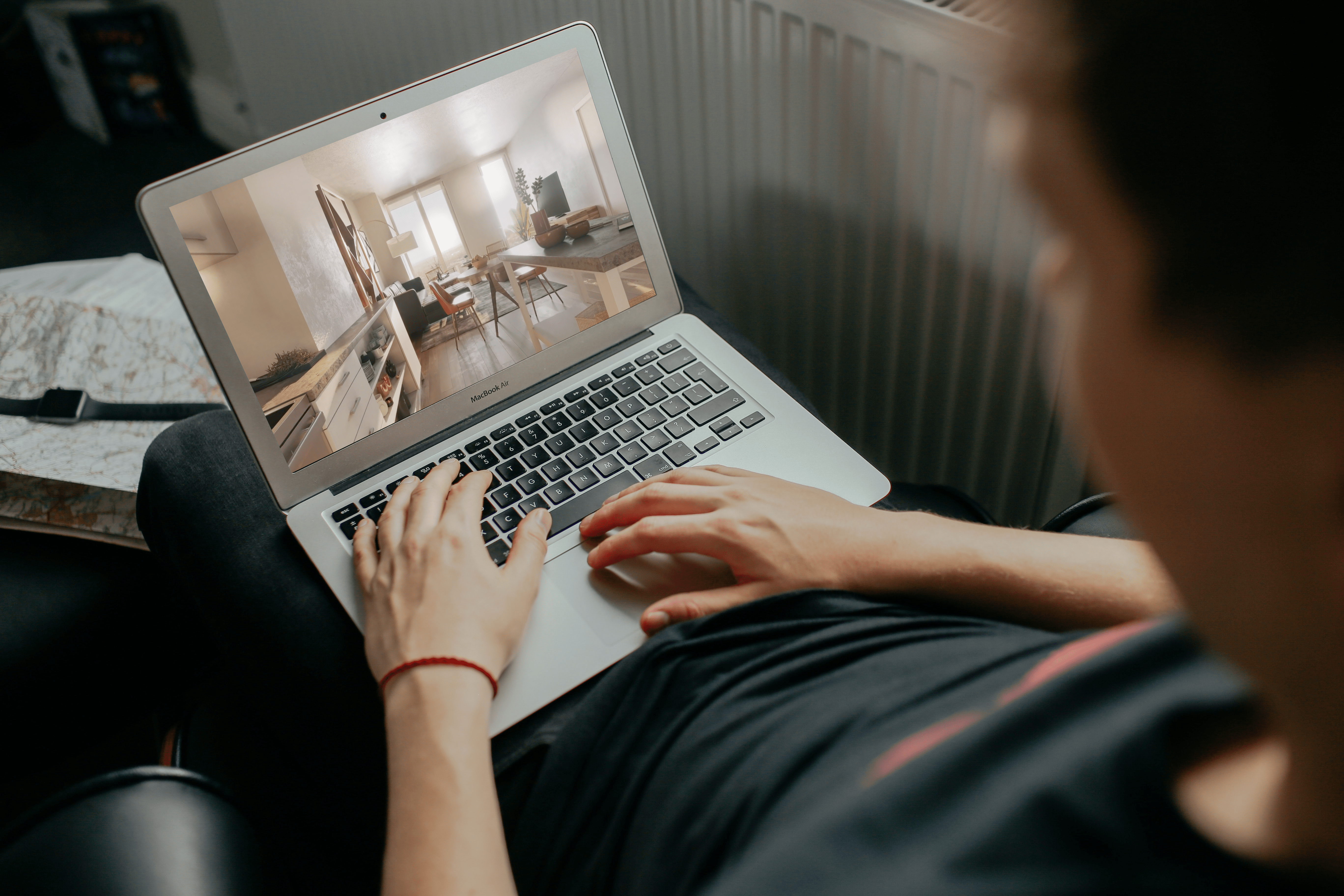 Person with Laptop Showing Photo of Multifamily Model